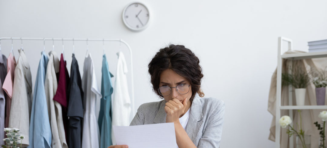 Mujer pensativa mientras lee un documento